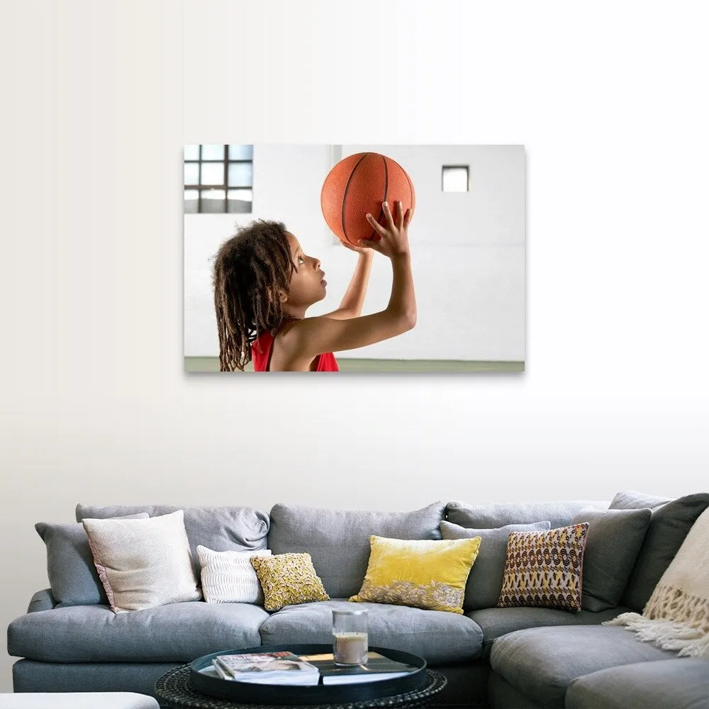 "Boy aiming a shot with a basketball in a school sports hall." Canvas Wall Art