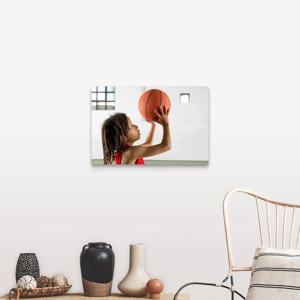 "Boy aiming a shot with a basketball in a school sports hall." Canvas Wall Art