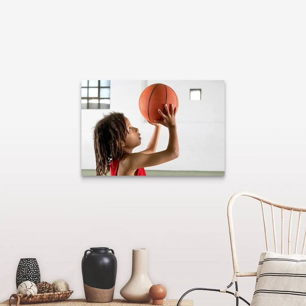 "Boy aiming a shot with a basketball in a school sports hall." Canvas Wall Art